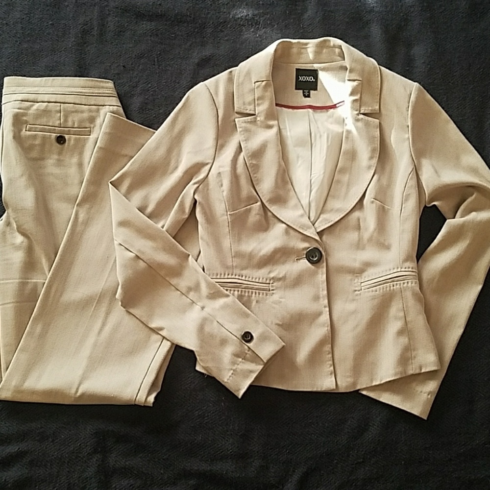 Light colored suit set with feminine details.